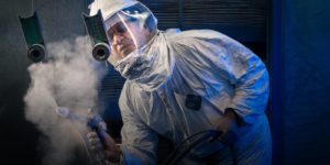 Hyatt Die Cast man in hazmat suit doing powder coating